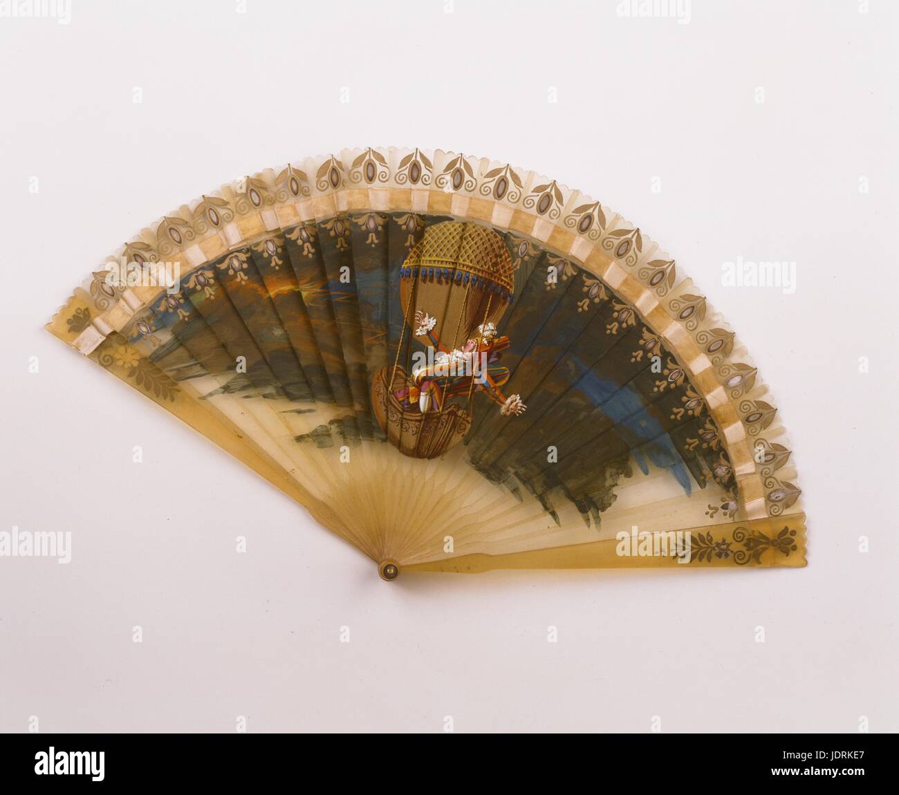 Concertina fan painted with a scene showing Polichinelle in a balloon during a storm.  Around 1825  Golden edging, gouache (31 x 16 cm)  Muller-Quênot Collection Stock Photo