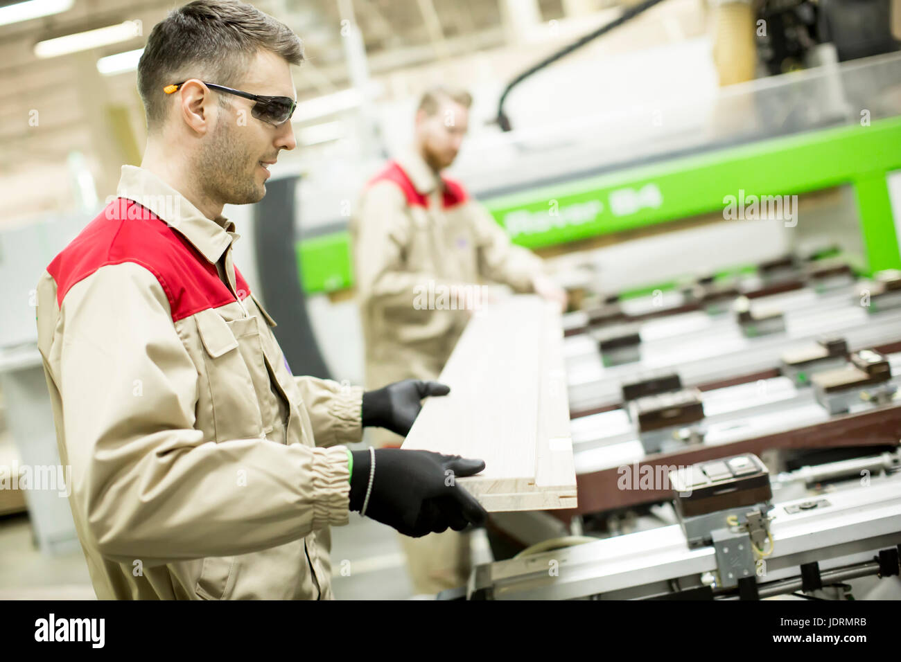 Two male workers working in furniture industry and creating custom