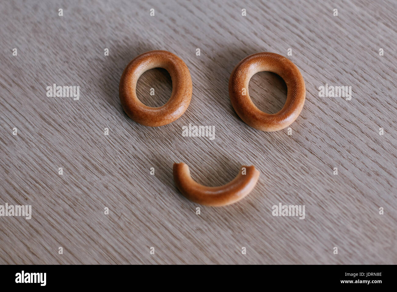 Smiley face cookie yellow hi-res stock photography and images - Alamy