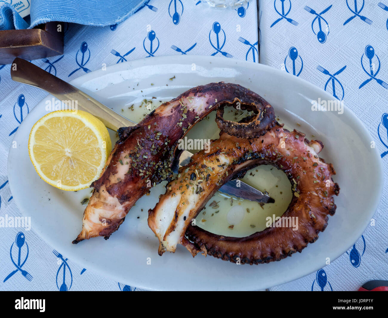 Grilled Octopus Tentacles with a slice of lemon Stock Photo
