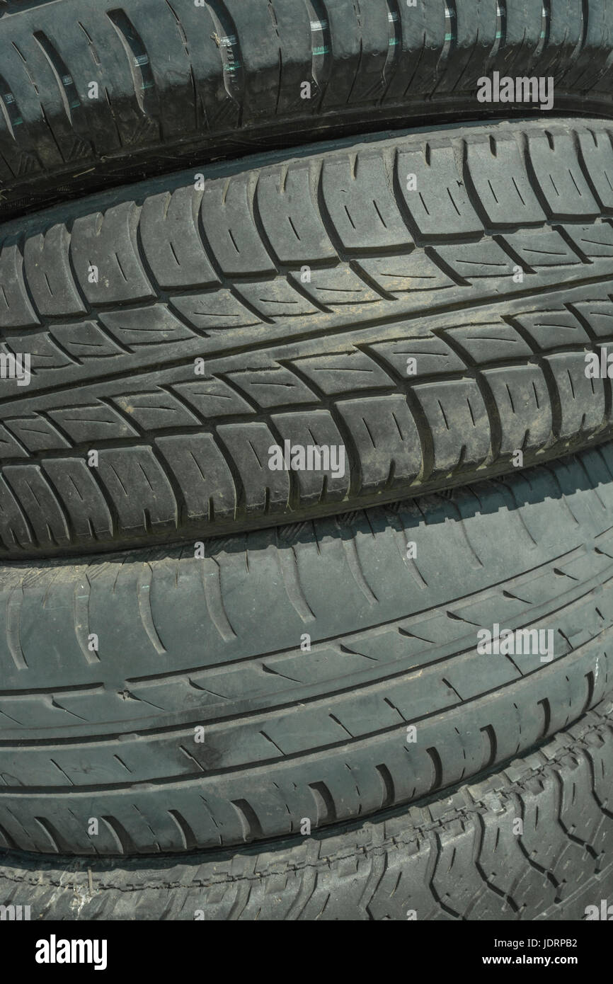 Old car tyres stacked up - for concept of recycling and environmental