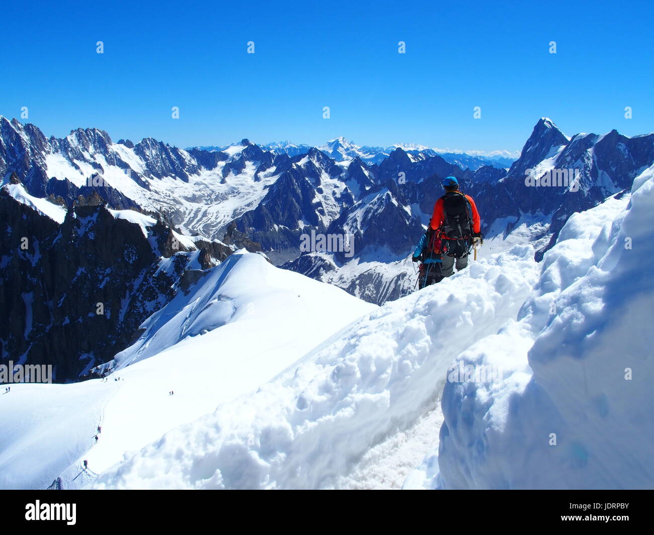 Two alpinists and mountaineer climber on AIGUILLE DU MIDI, CHAMONIX MONT BLANC french ALPS, top alpine mountains range landscape, FRANCE in 2016. Stock Photo