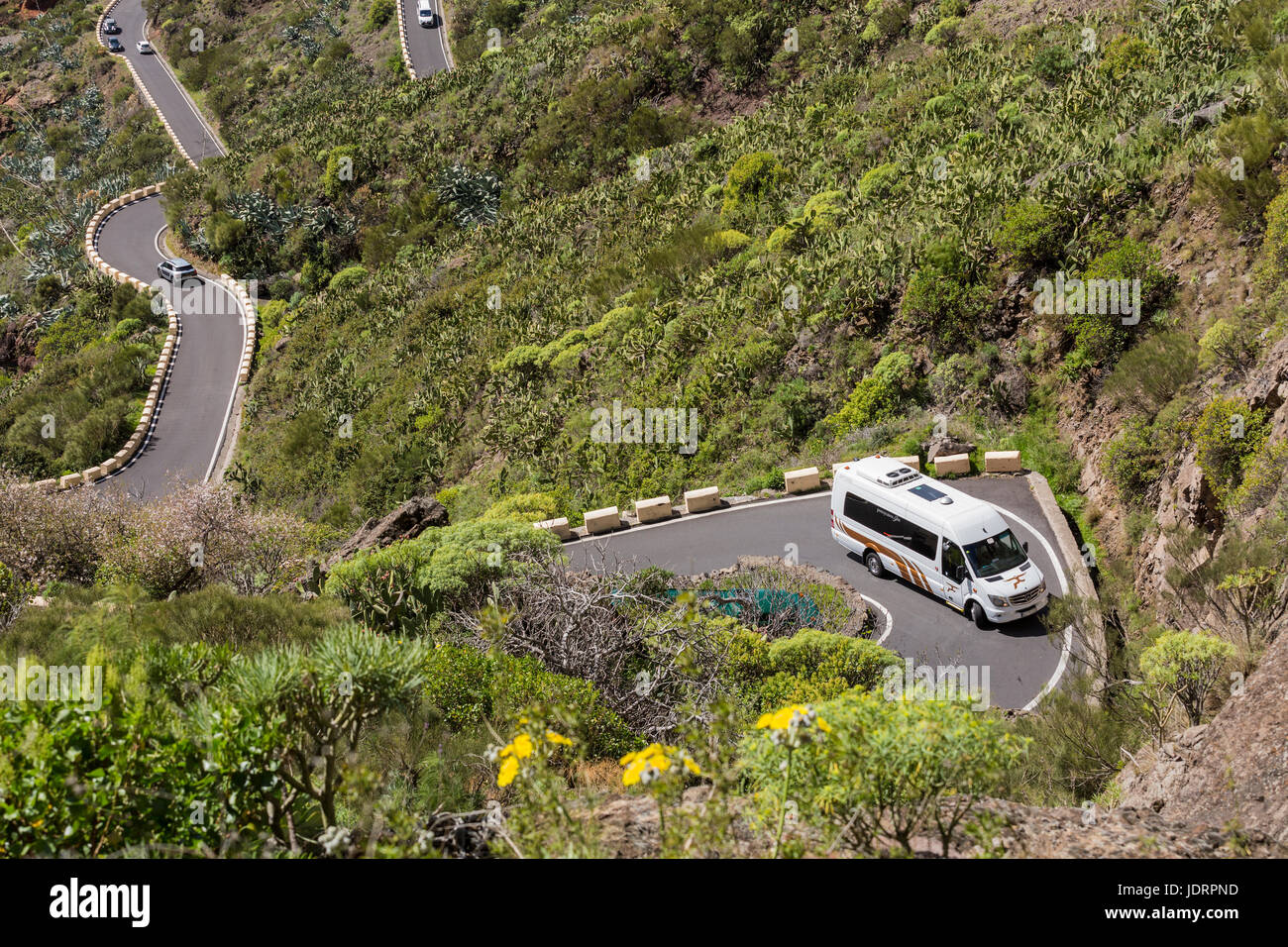 Traffic, minibuses, cars, coaches on the narrow mountain road from Santiago del Teide to Masca in Tenerife, Canary Islands, Spain Stock Photo