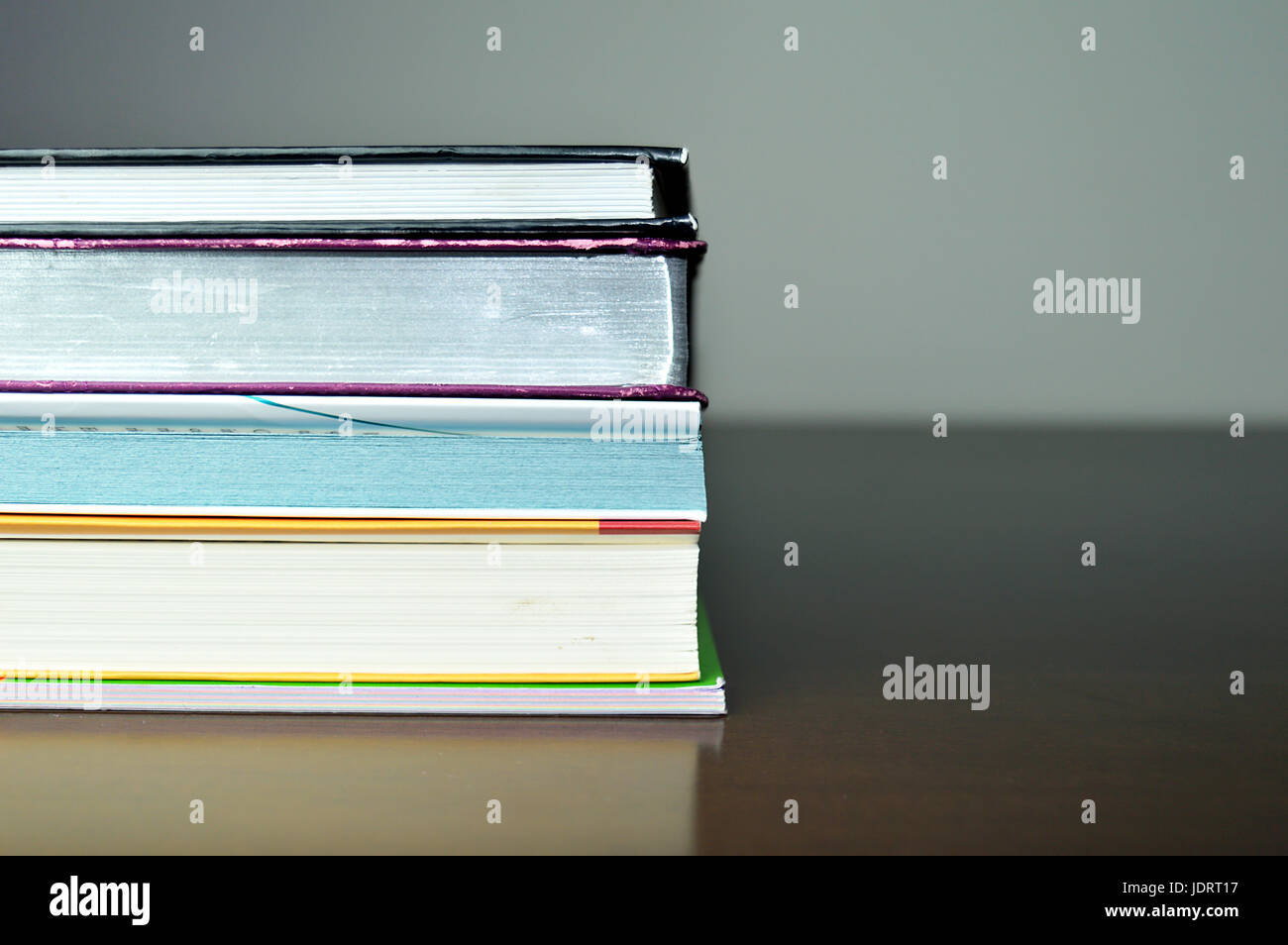 Pile of Books on the table against a gray background Stock Photo - Alamy