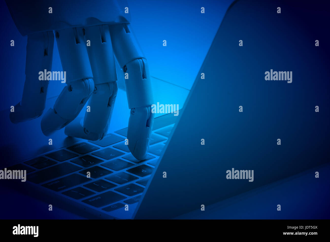 Chat bot , artificial intelligence , robo advisor , robotic concept. Robot finger point to laptop button. Blue tone. Stock Photo