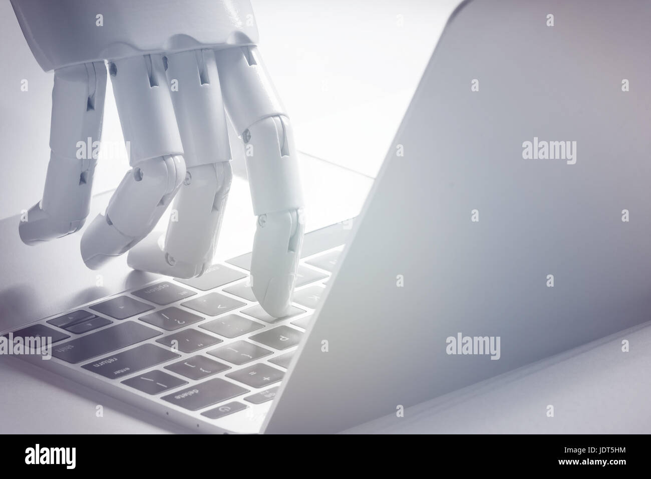 Artificial intelligence , robo advisor , chabot , robotic concept. Robot finger point to laptop button. Stock Photo