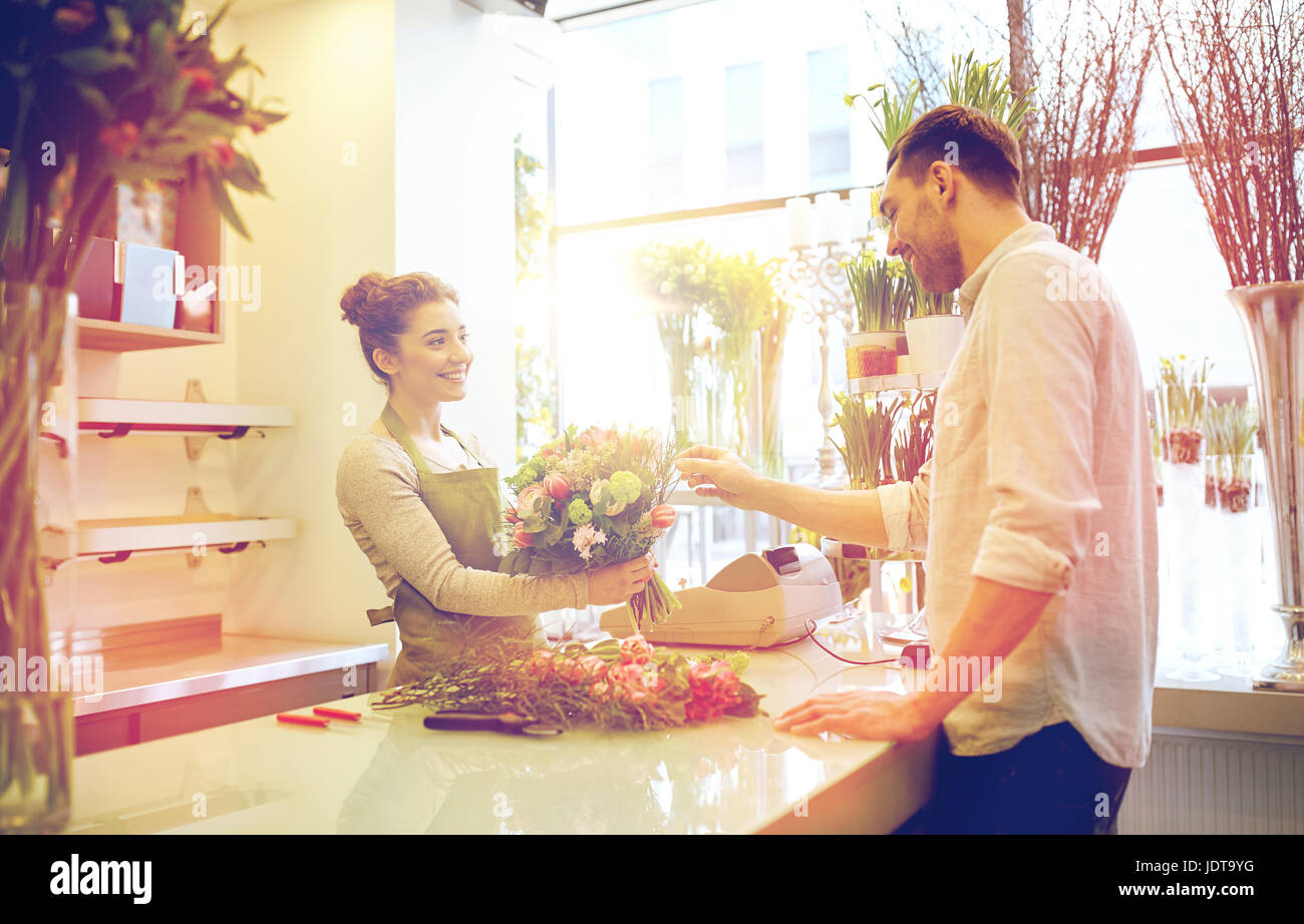 smiling florist woman and man at flower shop Stock Photo - Alamy