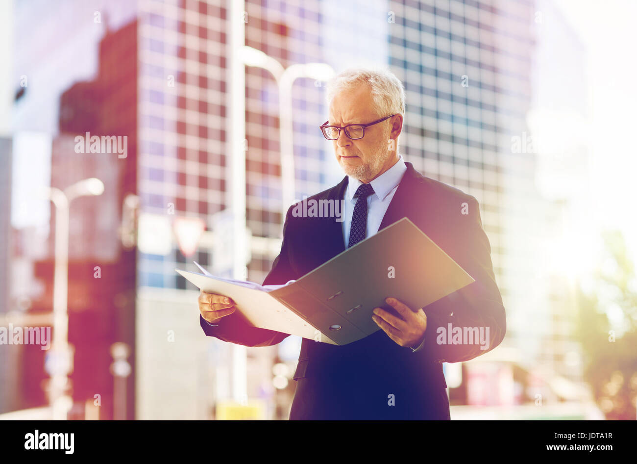 senior businessman with ring binder folder in city Stock Photo