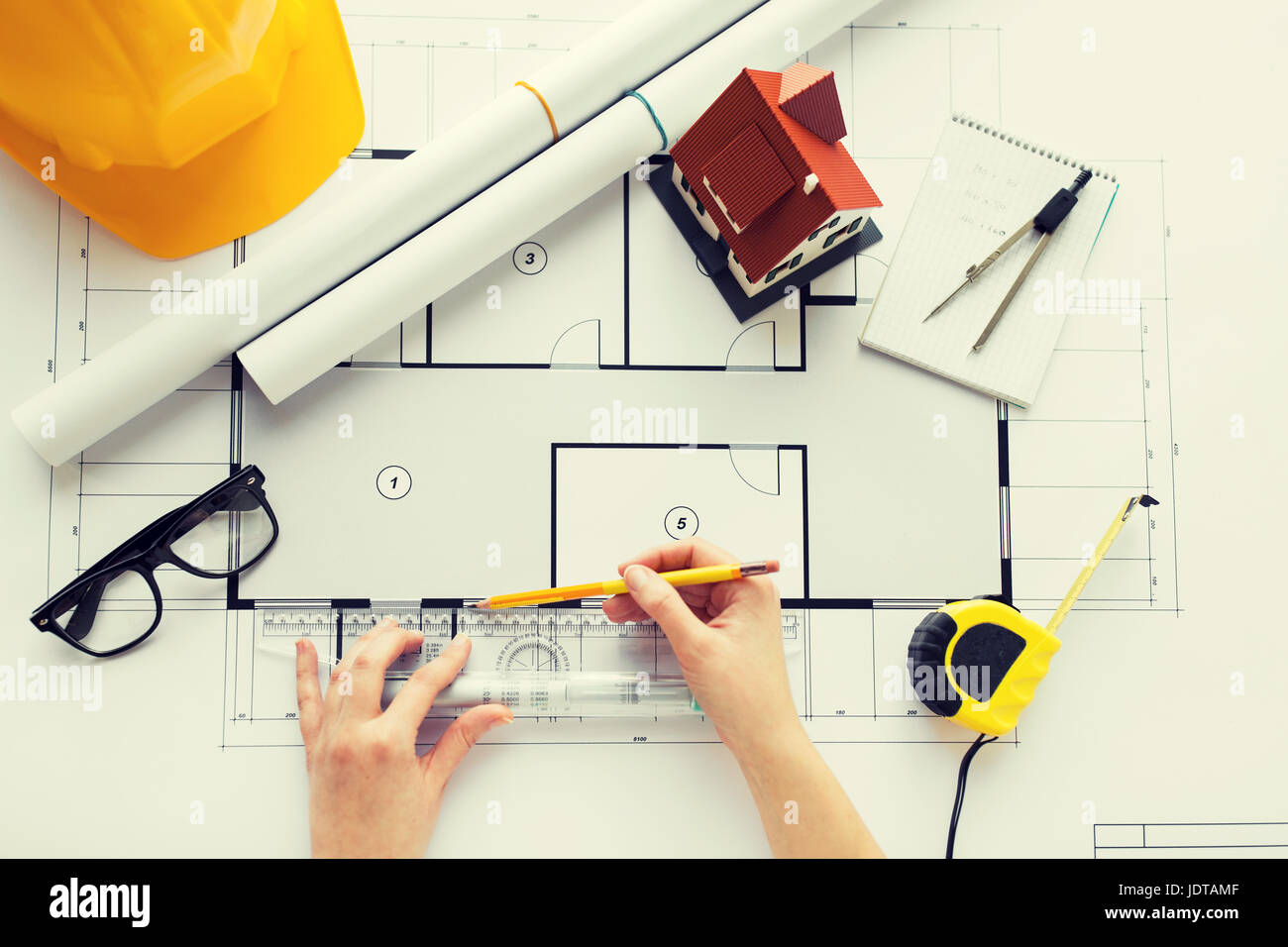 close up of hands with ruler measuring blueprint Stock Photo - Alamy