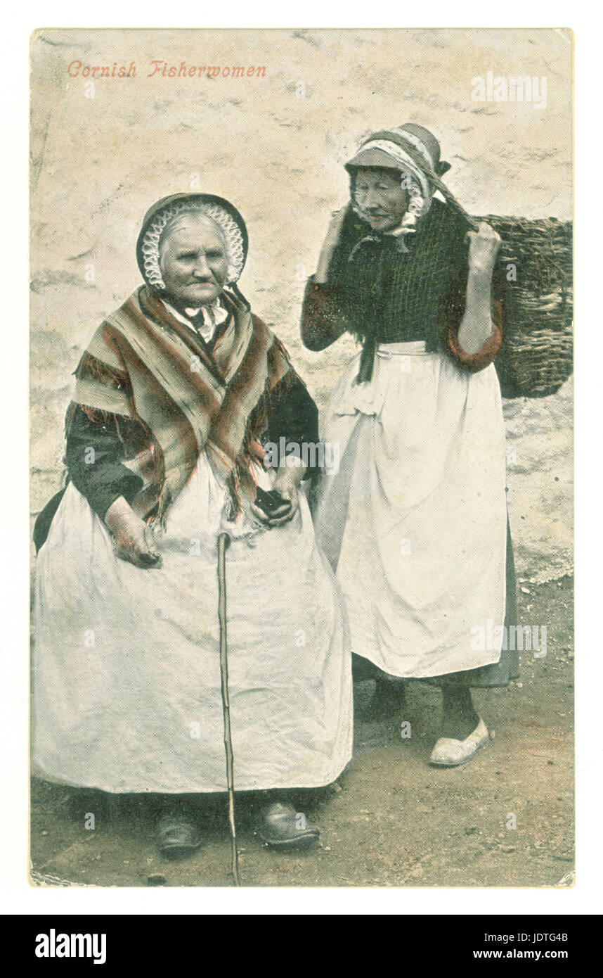 Original Edwardian era tinted colour postcard of Cornish Fisherwomen, wearing lace bonnets and shawls, carrying baskets or cauwals,  posted from St. Ives, Cornwall, U.K. August 1906 Stock Photo