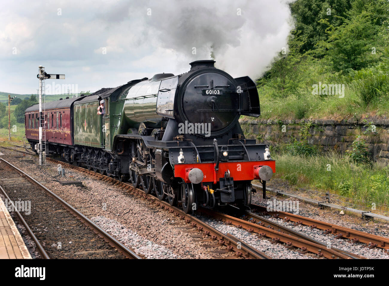 The Flying Scotsman passes through Hellifield Station in North Yorkshire  on the way to the National Railway Museum in York, UK Stock Photo