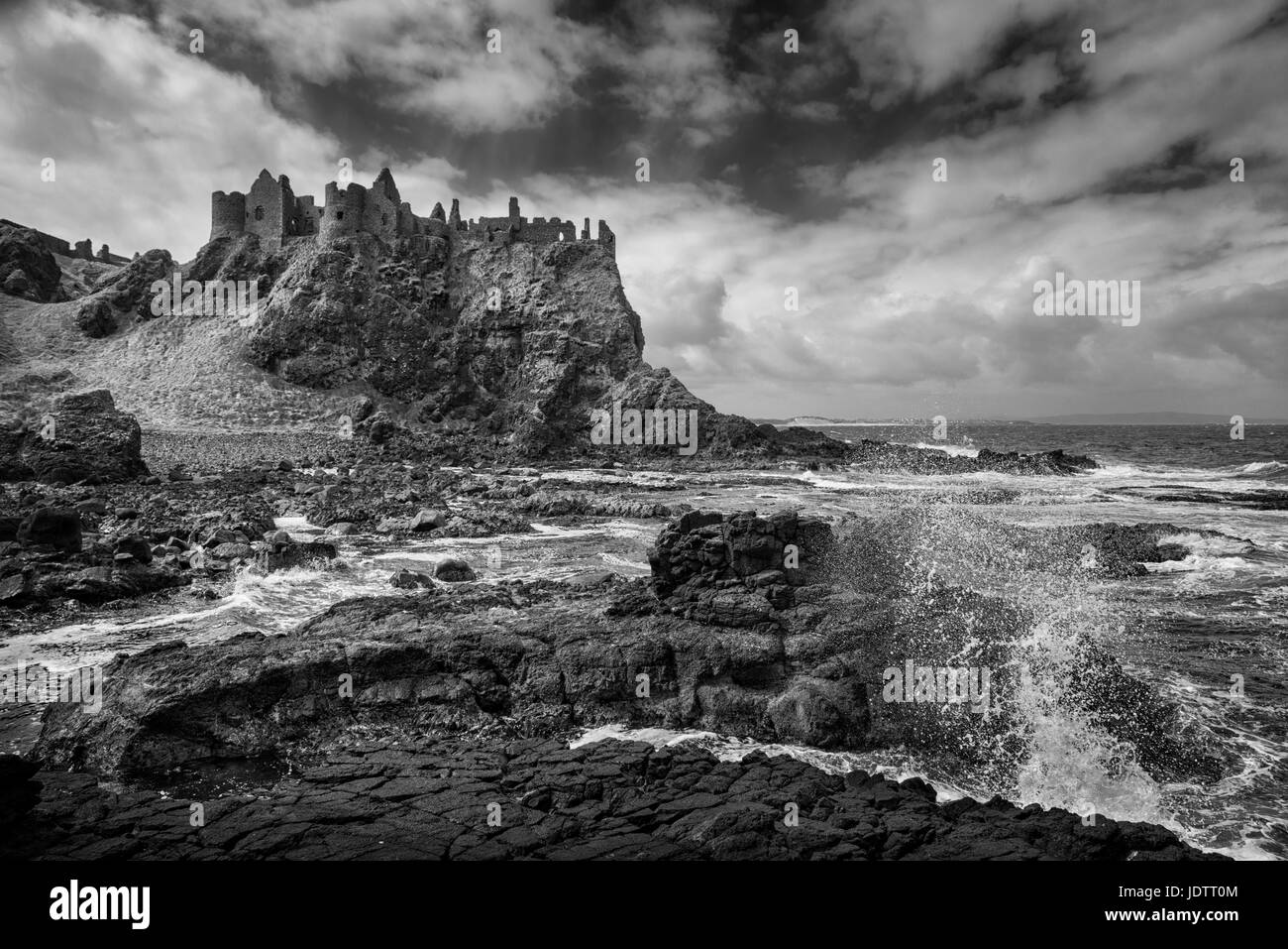 Dunluce Castle in a dramatic clifftop setting on the Causeway Coast of County Antrim Northern Ireland Stock Photo