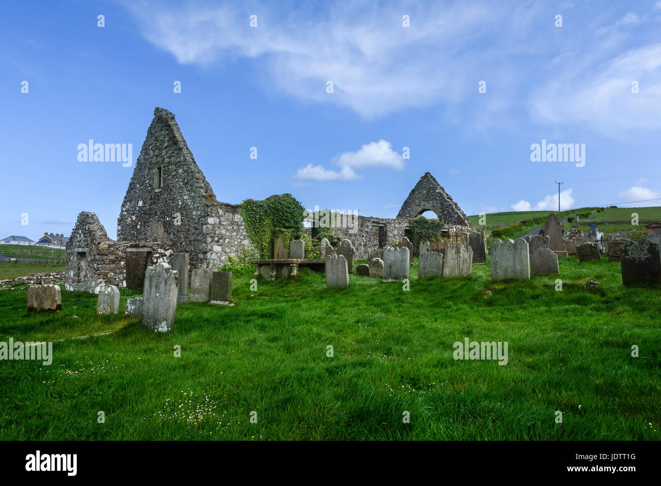 Old ruined church  and graveyard  of St. Cuthbert's at Dunluce in County Antrim Stock Photo