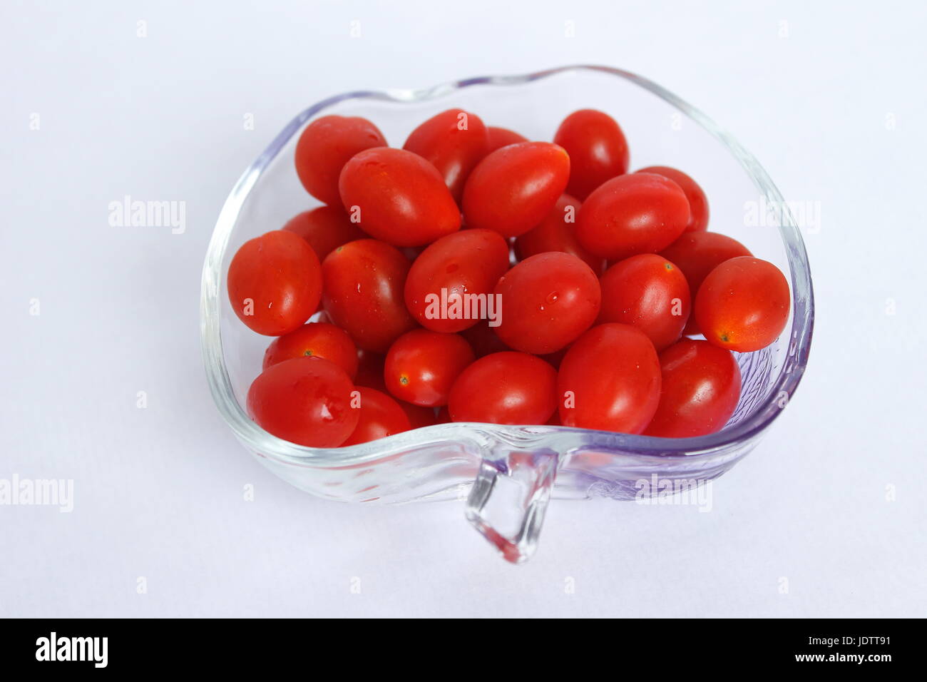 Small cherry tomatoes long red and fresh in a cup Stock Photo