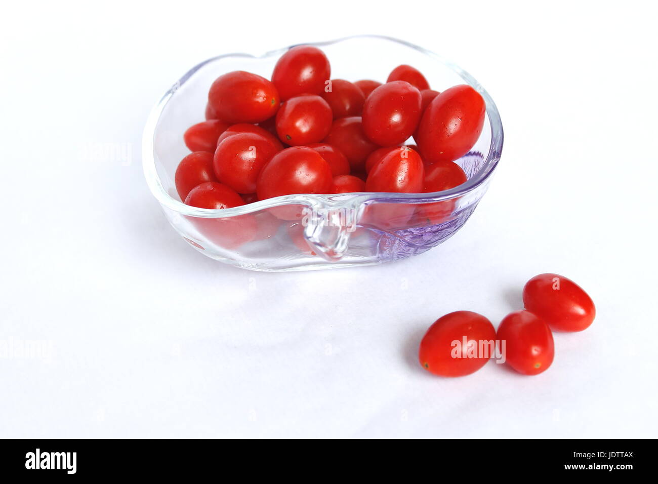 Small cherry tomatoes long red and fresh in a cup Stock Photo