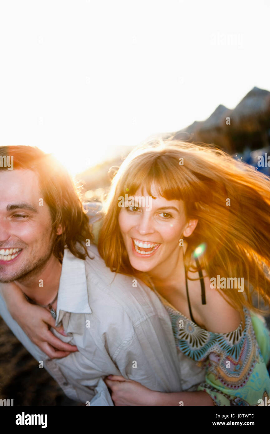 Young couple having fun on beach Stock Photo - Alamy