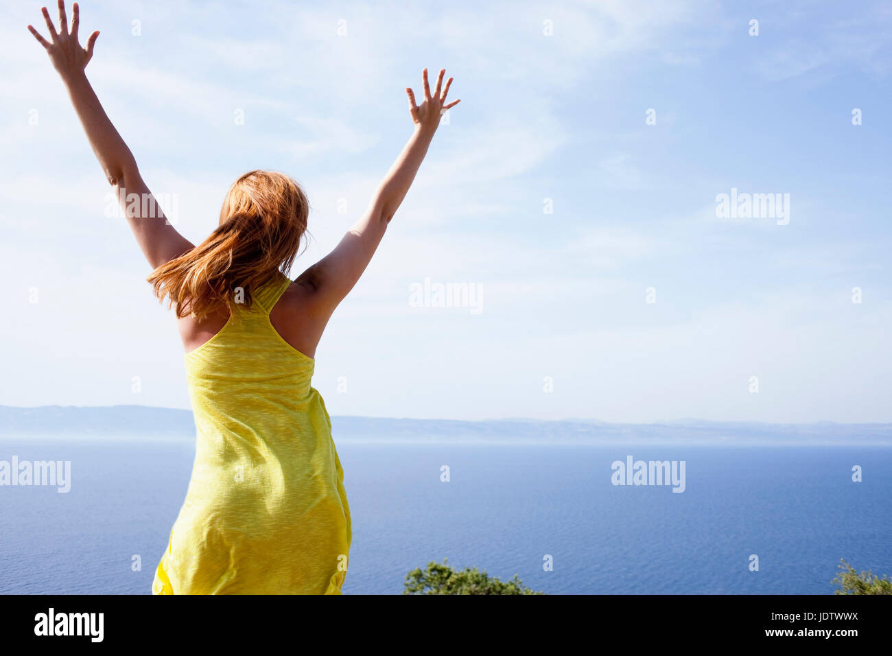 Woman embracing sky Stock Photo