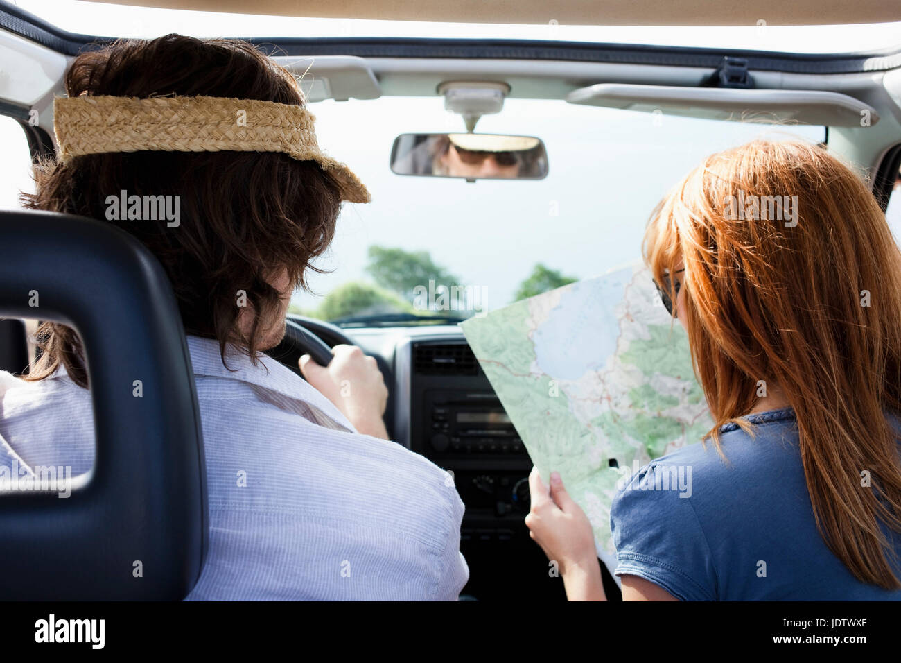Couple in car looking at map Stock Photo