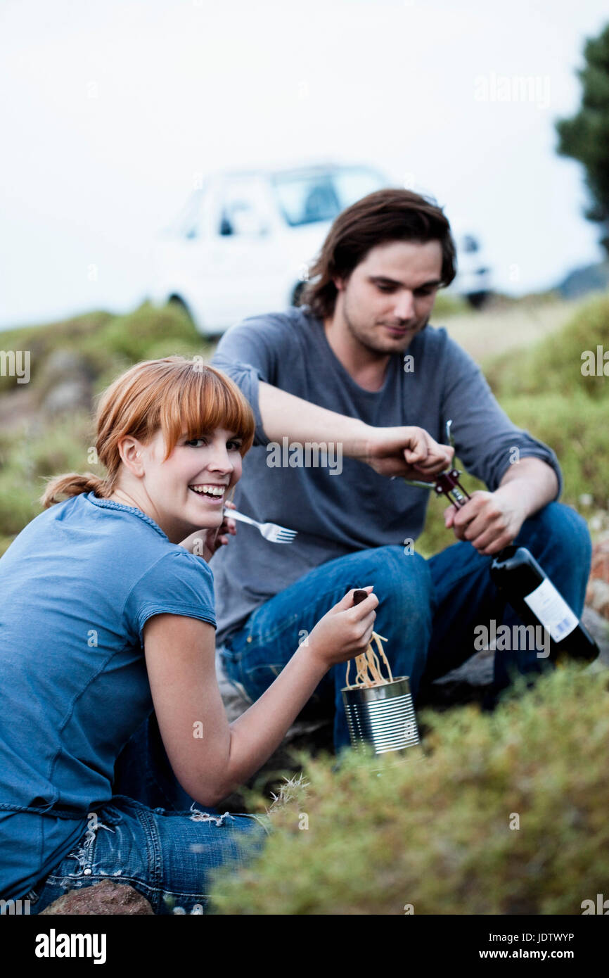 Couple cooking dinner outdoors Stock Photo