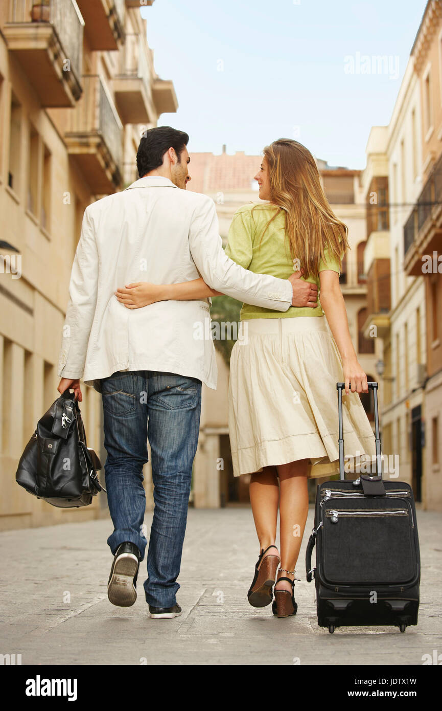 Couple walking with luggage Stock Photo
