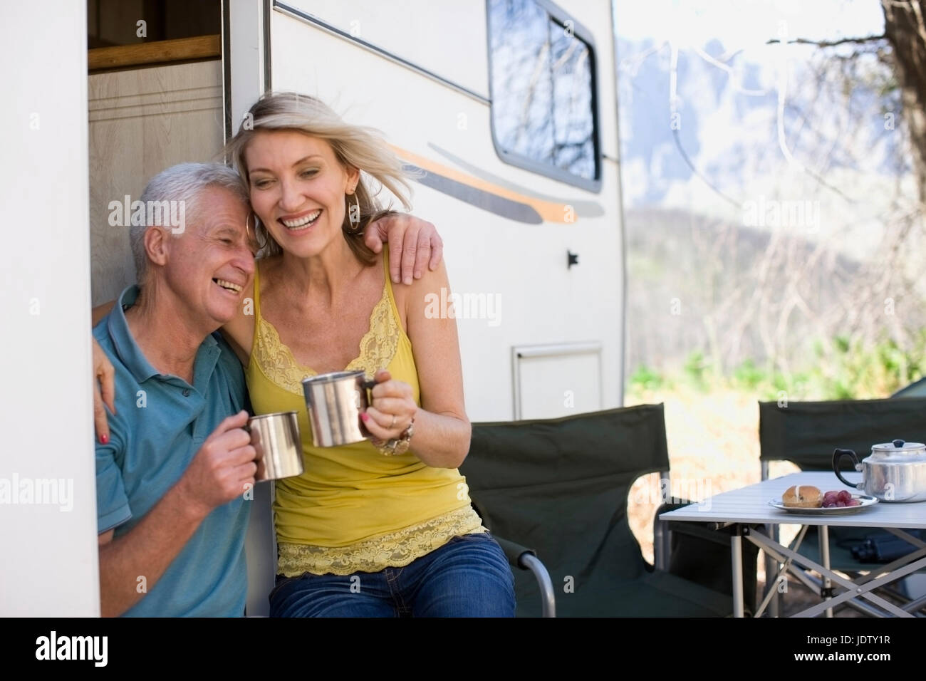 Older couple camping with RV Stock Photo