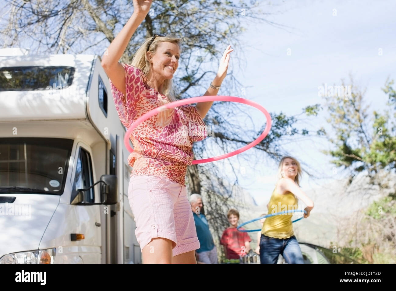Family using hula hoops with RV Stock Photo