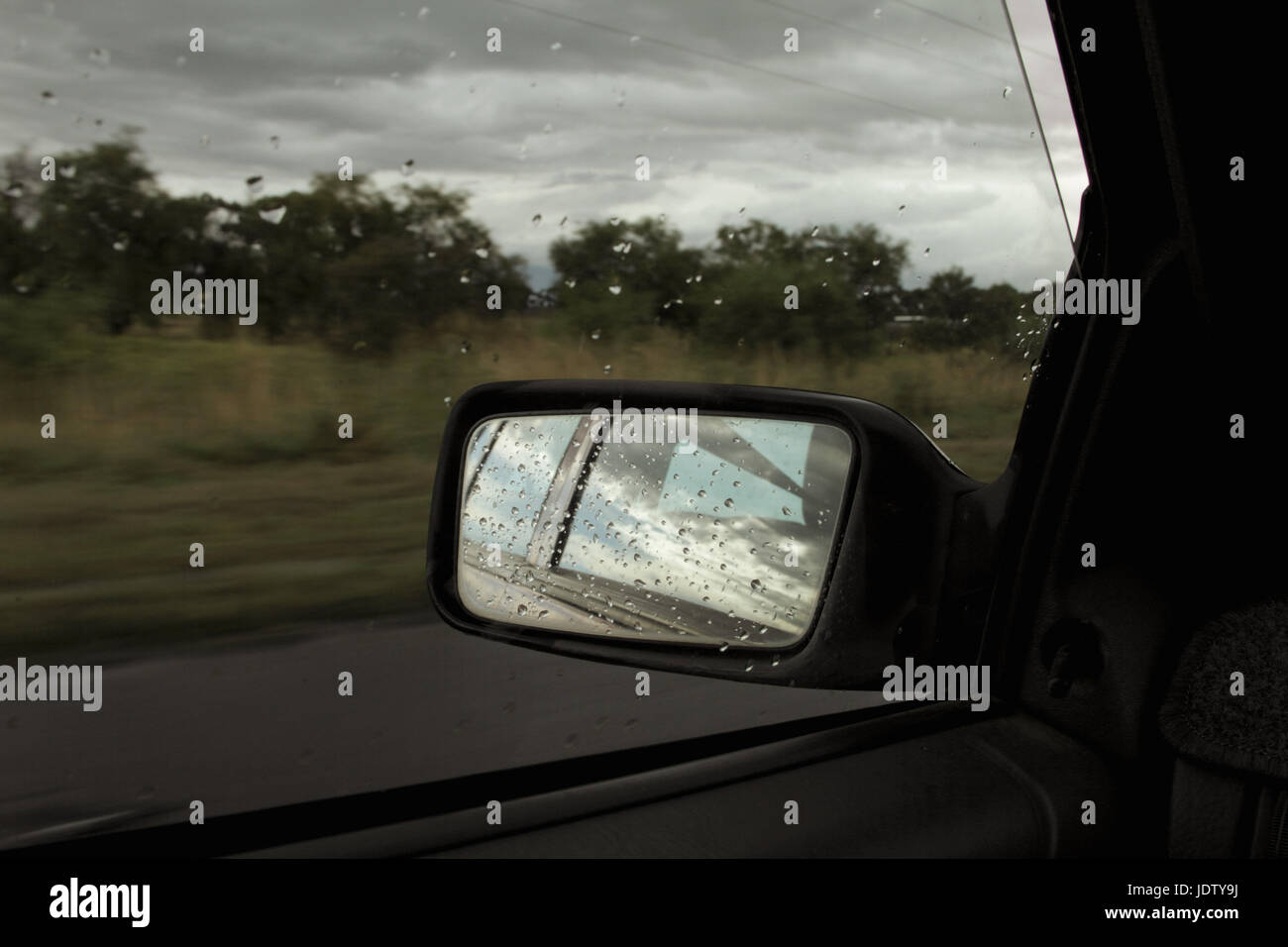 Rain on car mirror window hi-res stock photography and images - Alamy