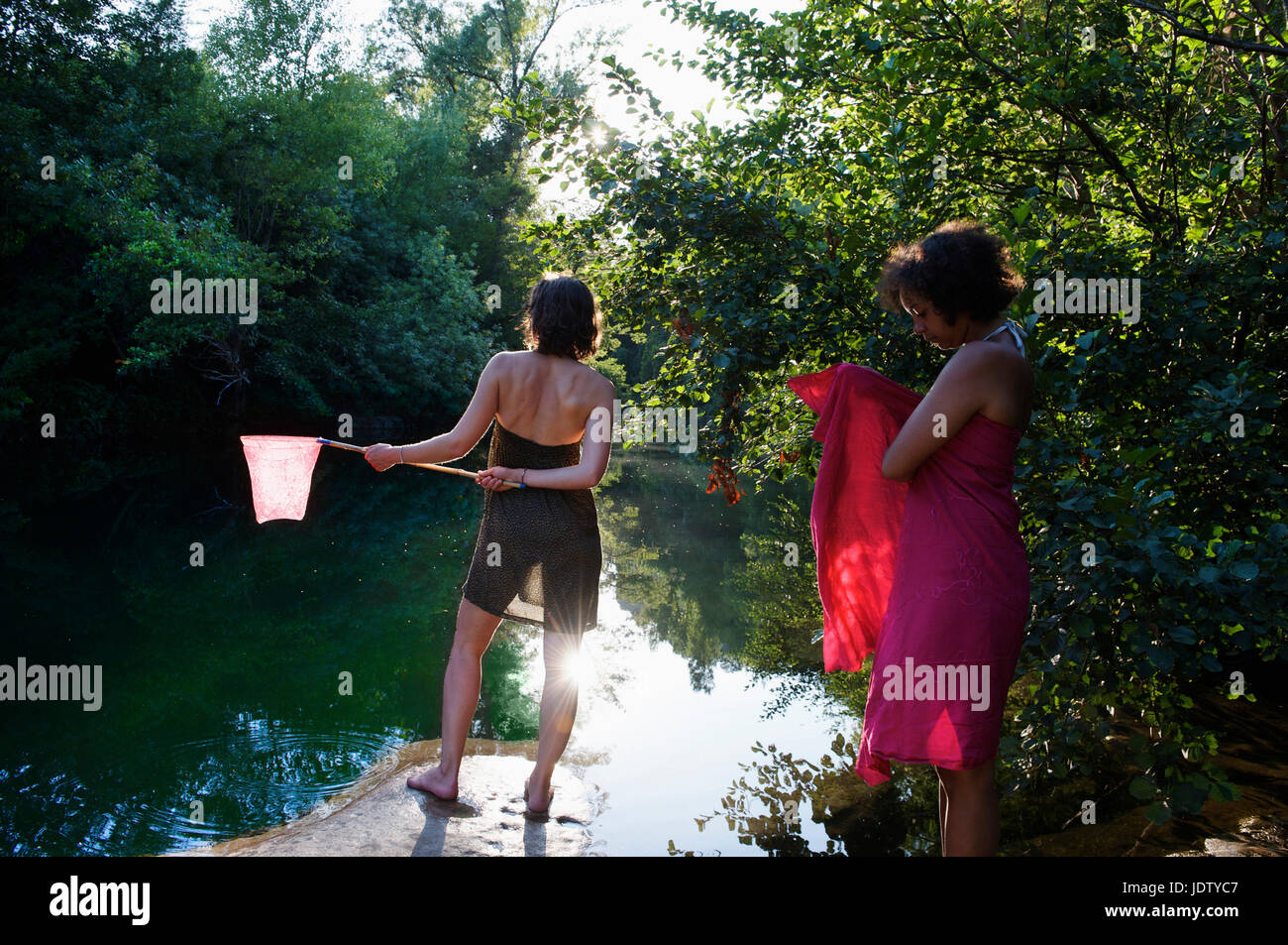 Women standing by river Stock Photo - Alamy