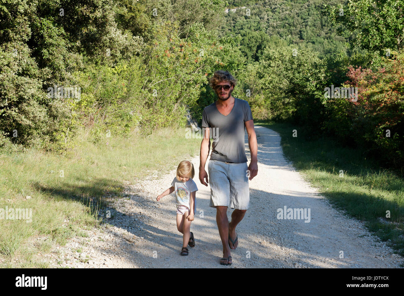 Father and daughter walking on dirt path Stock Photo - Alamy