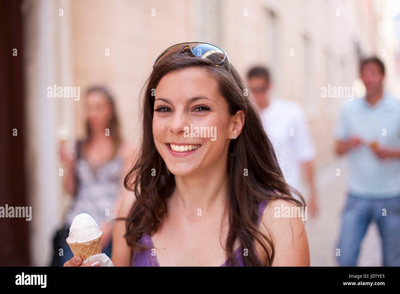 Smiling woman with ice cream cone Stock Photo