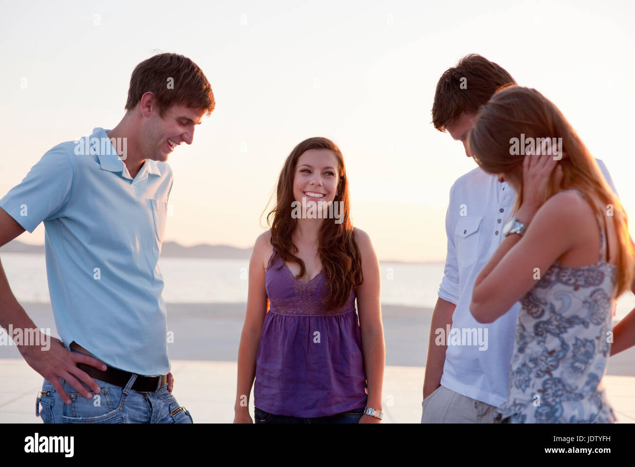 Couples standing on pier outdoors Stock Photo
