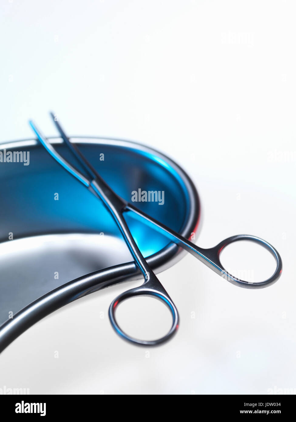 Close up of scissor forceps in bowl Stock Photo