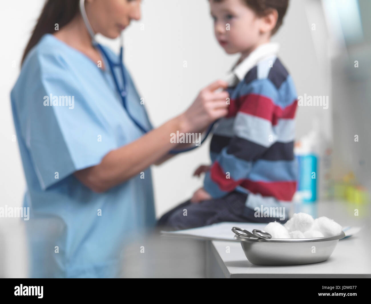 Nurse examining boy in doctors office Stock Photo