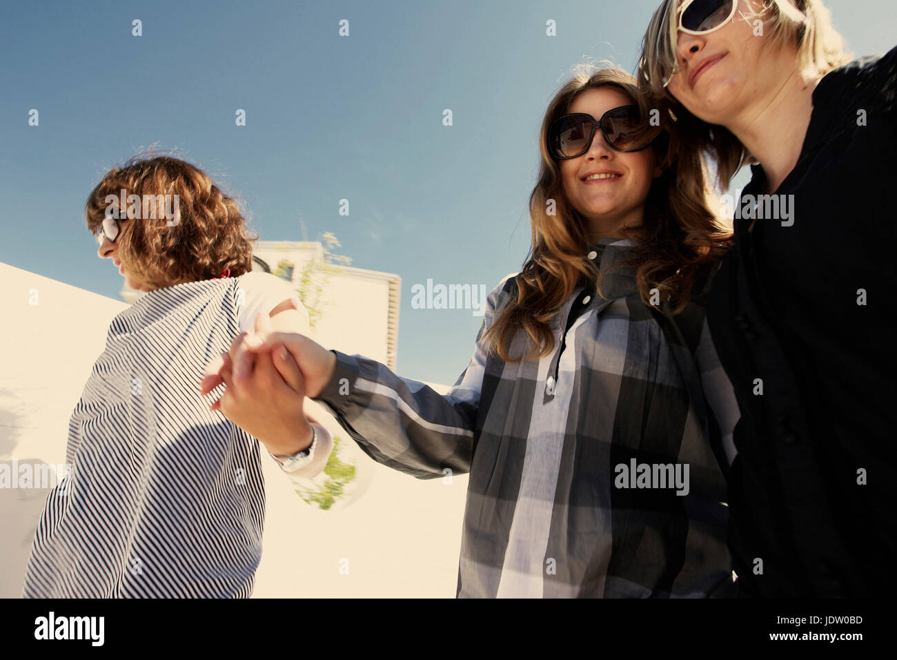 Women holding hands outdoors Stock Photo - Alamy