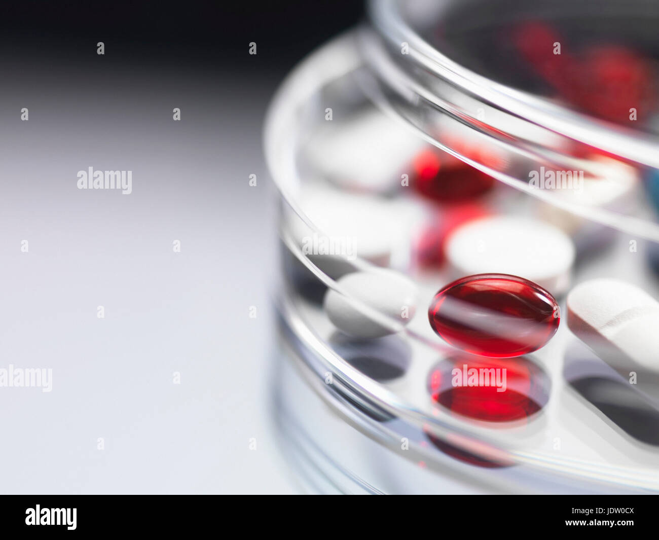 Close up of pills in clear jar Stock Photo