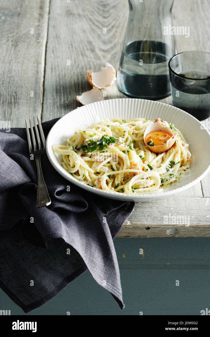 Bowl of pasta carbonara with egg Stock Photo