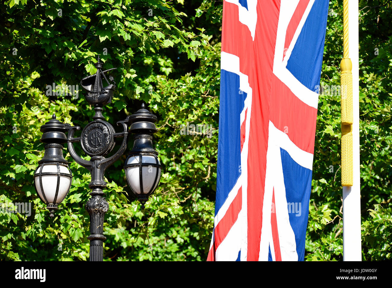 Decorated lamps lining The Mall London with galleon with the G I R royal cypher of George I. Galleons linked to Admiral Nelson of that era. Union flag Stock Photo