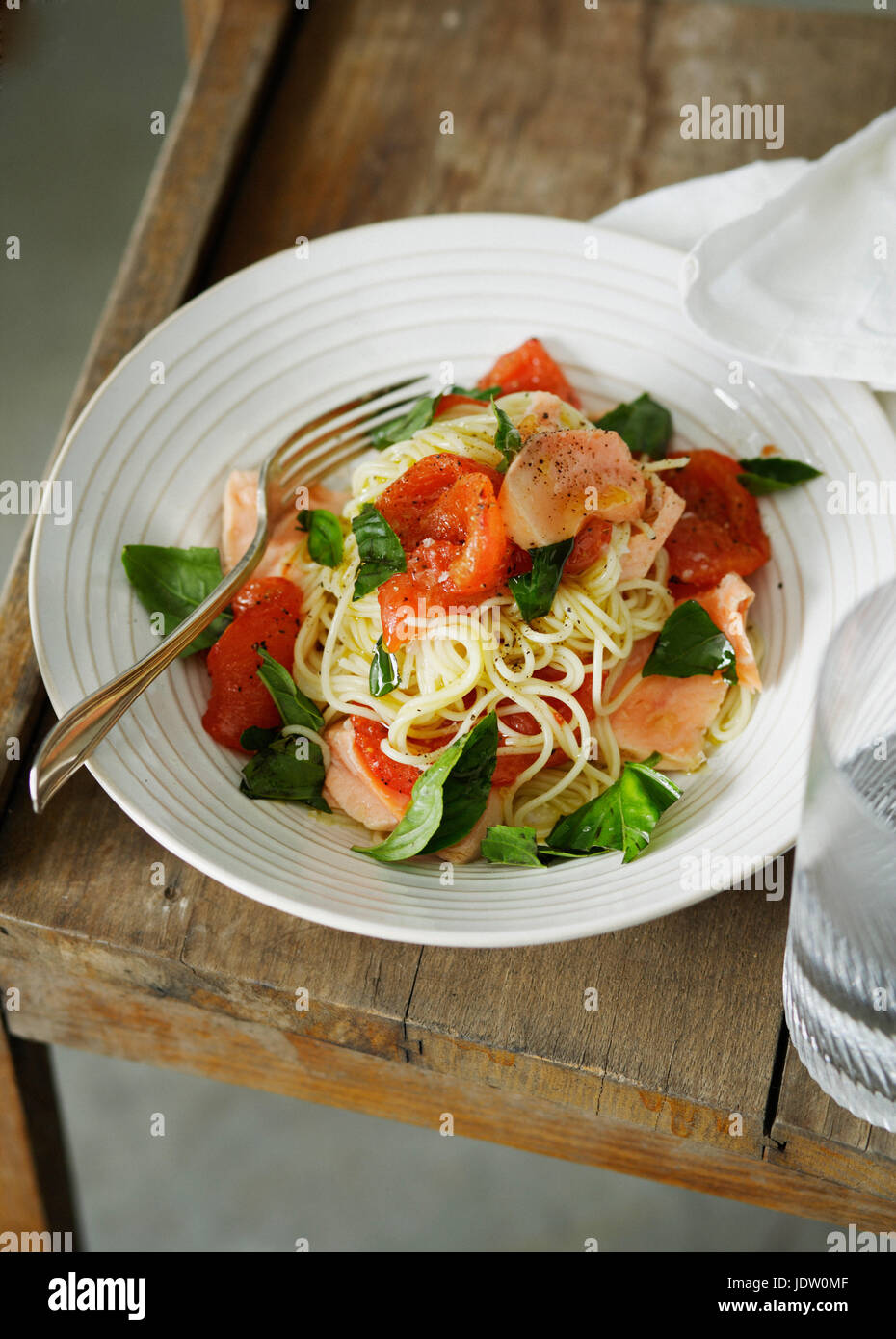 Plate of fish and tomato pasta Stock Photo