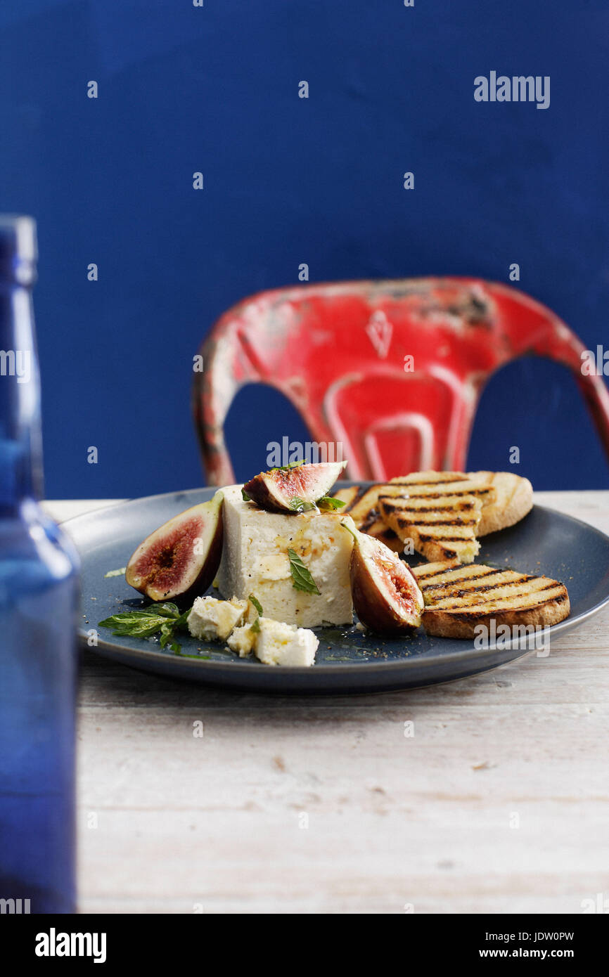Plate of baked ricotta, figs and bread Stock Photo