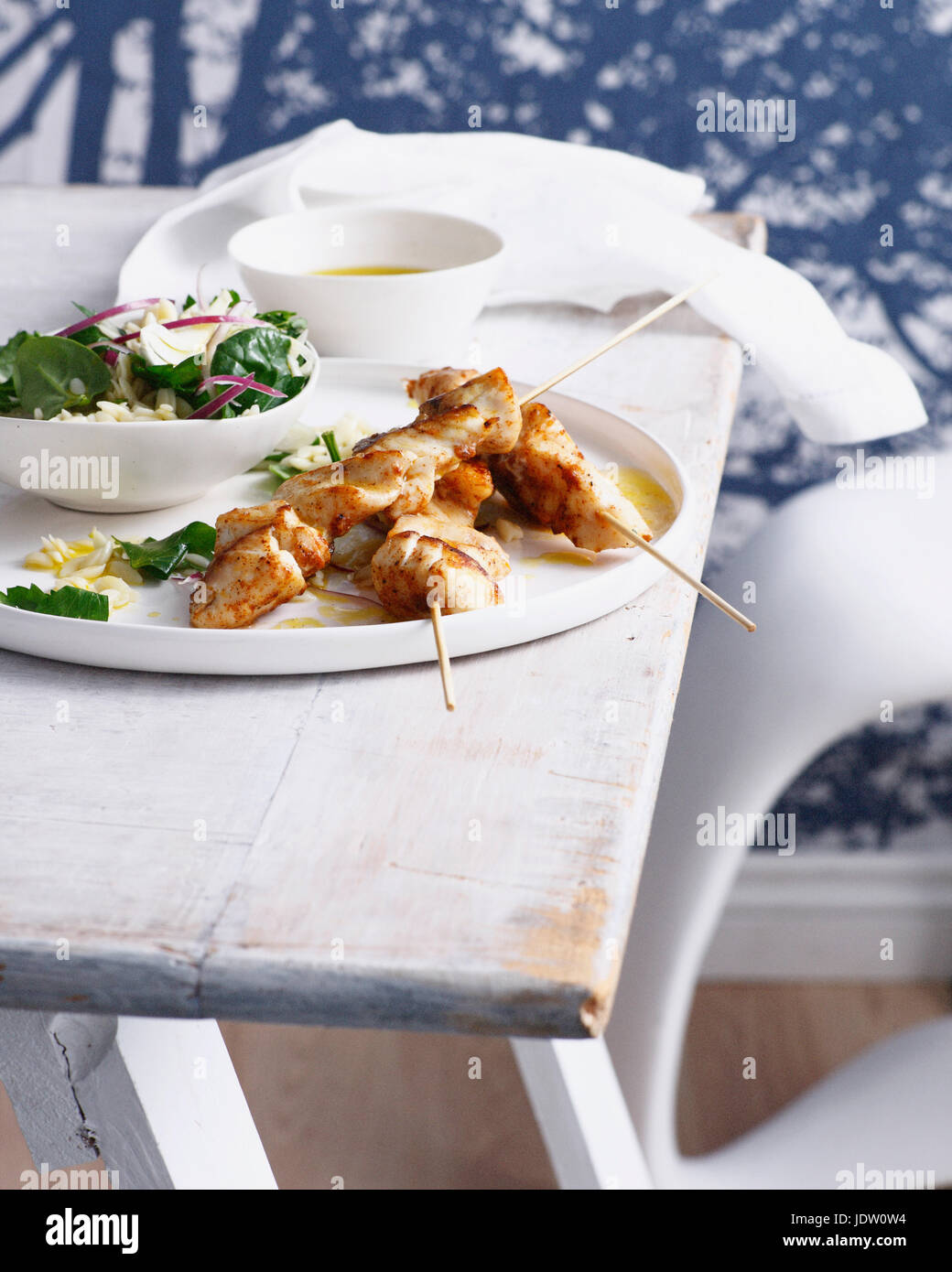 Plate of fish skewers with salad Stock Photo