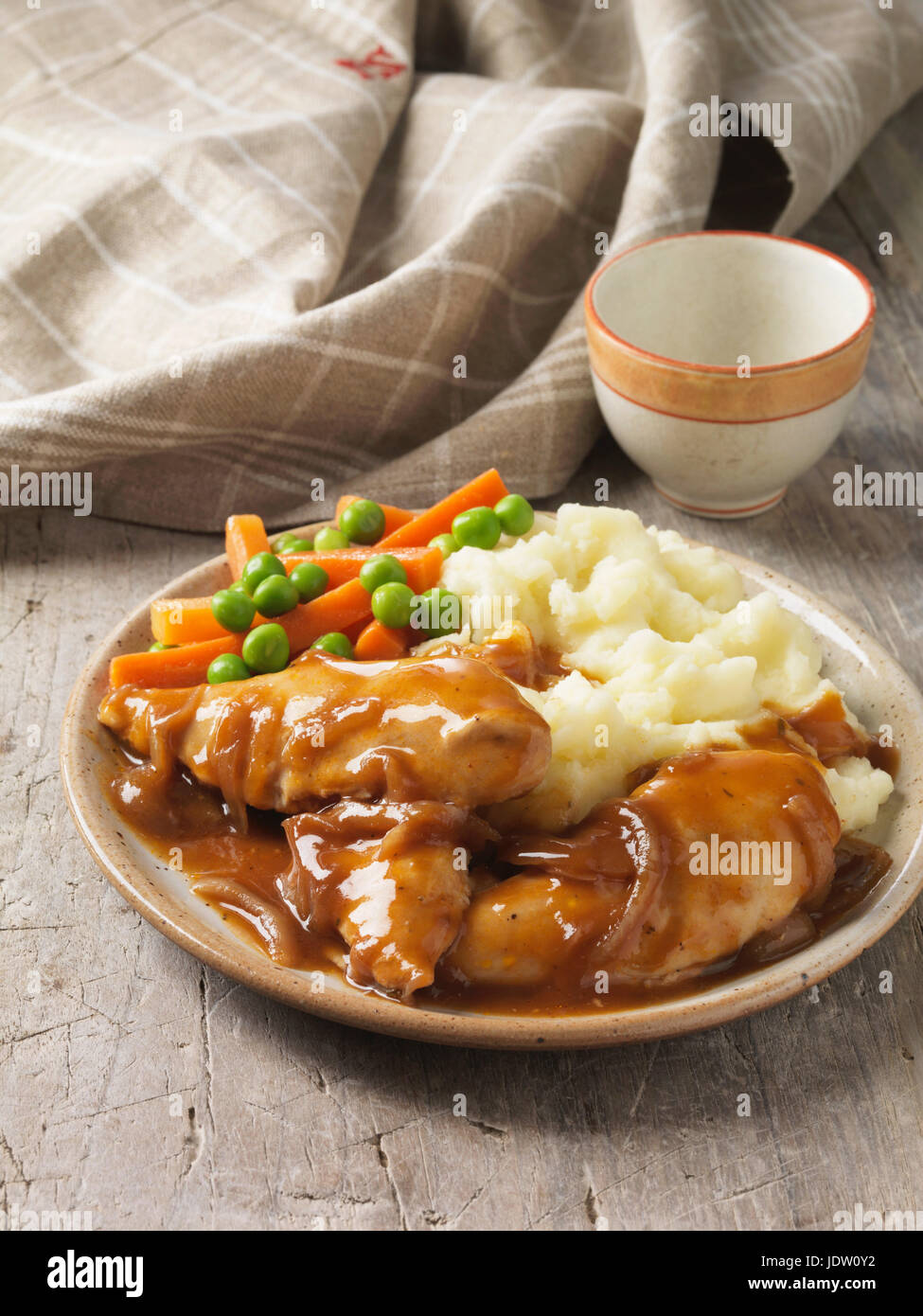 Plate of chicken, gravy and vegetables Stock Photo