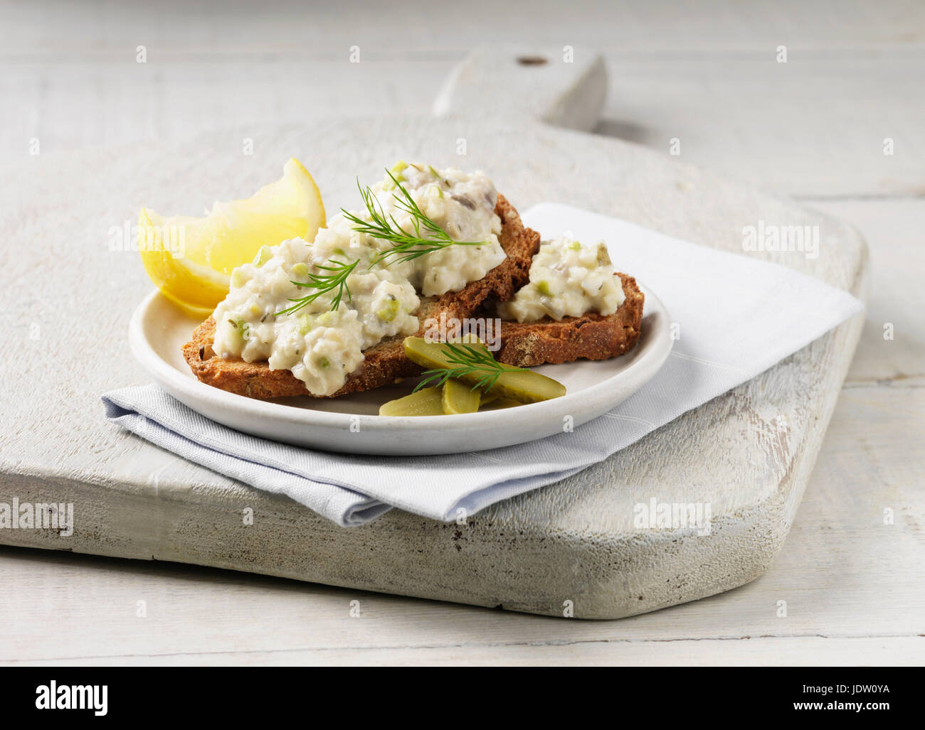 Plate of toast with herring and lemon Stock Photo