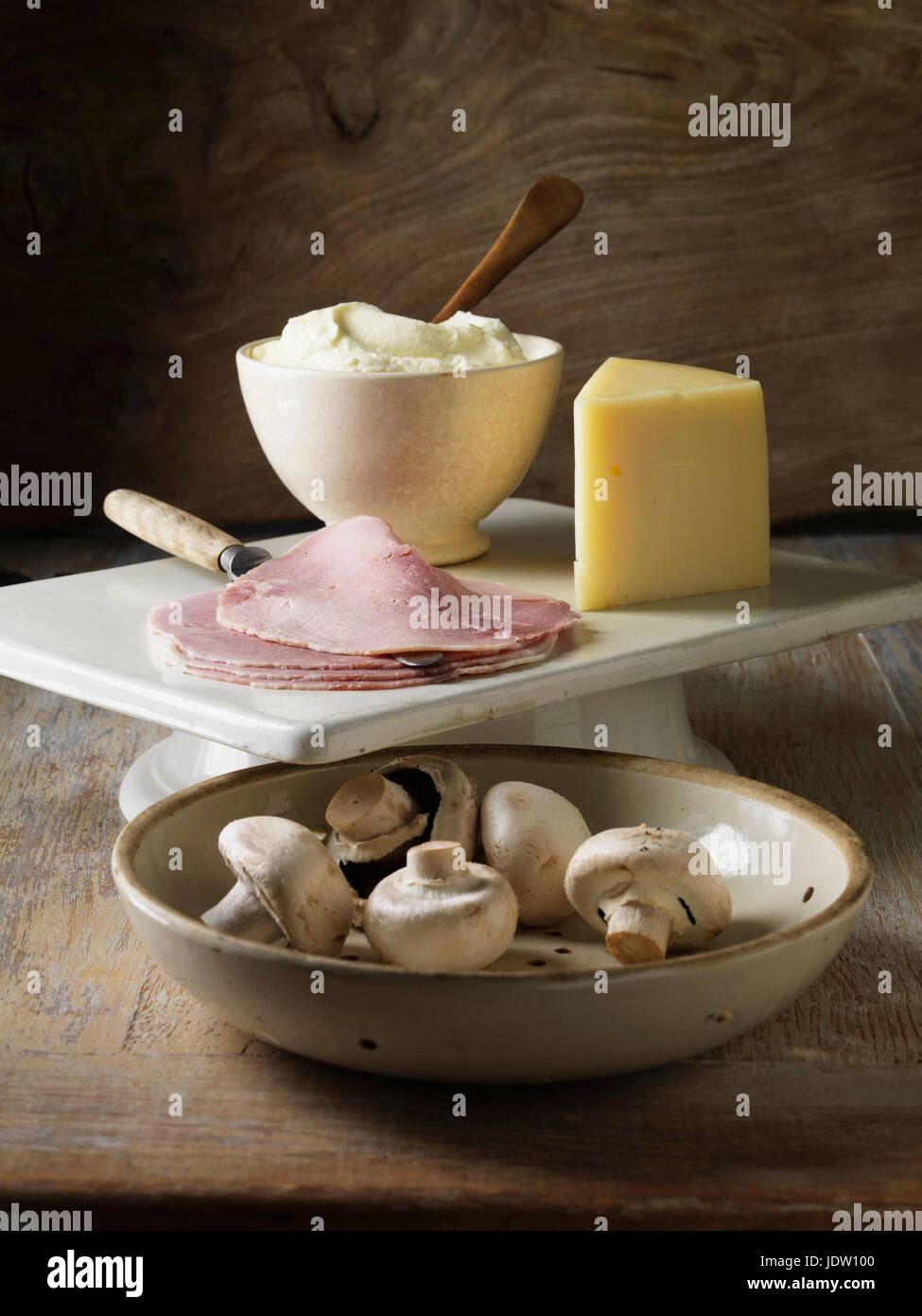 Mushrooms, ham and cheese on board Stock Photo
