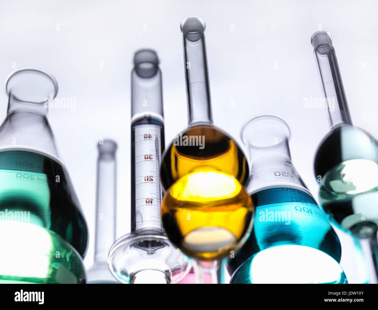 Beakers with liquids on reflective table Stock Photo