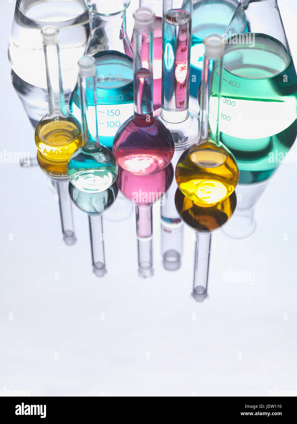 Beakers with liquids on reflective table Stock Photo