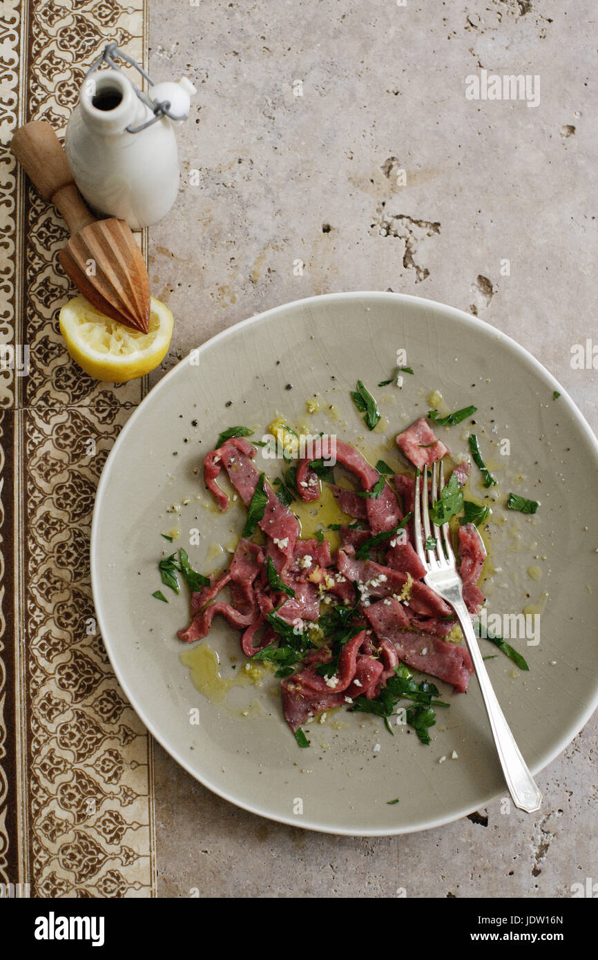 Plate of meat with salad and lemon Stock Photo