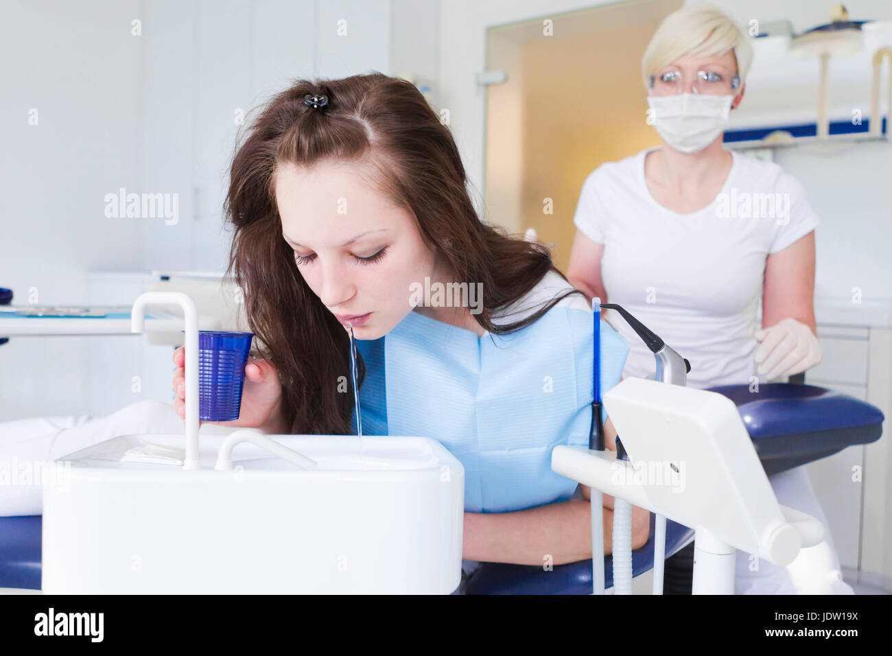 Dental patient spitting in sink Stock Photo Alamy