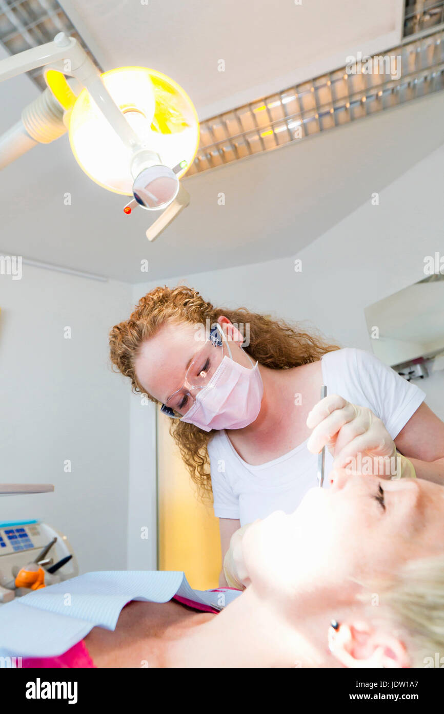Tooth Working Dentist working on patients teeth hi-res stock photography and images ...