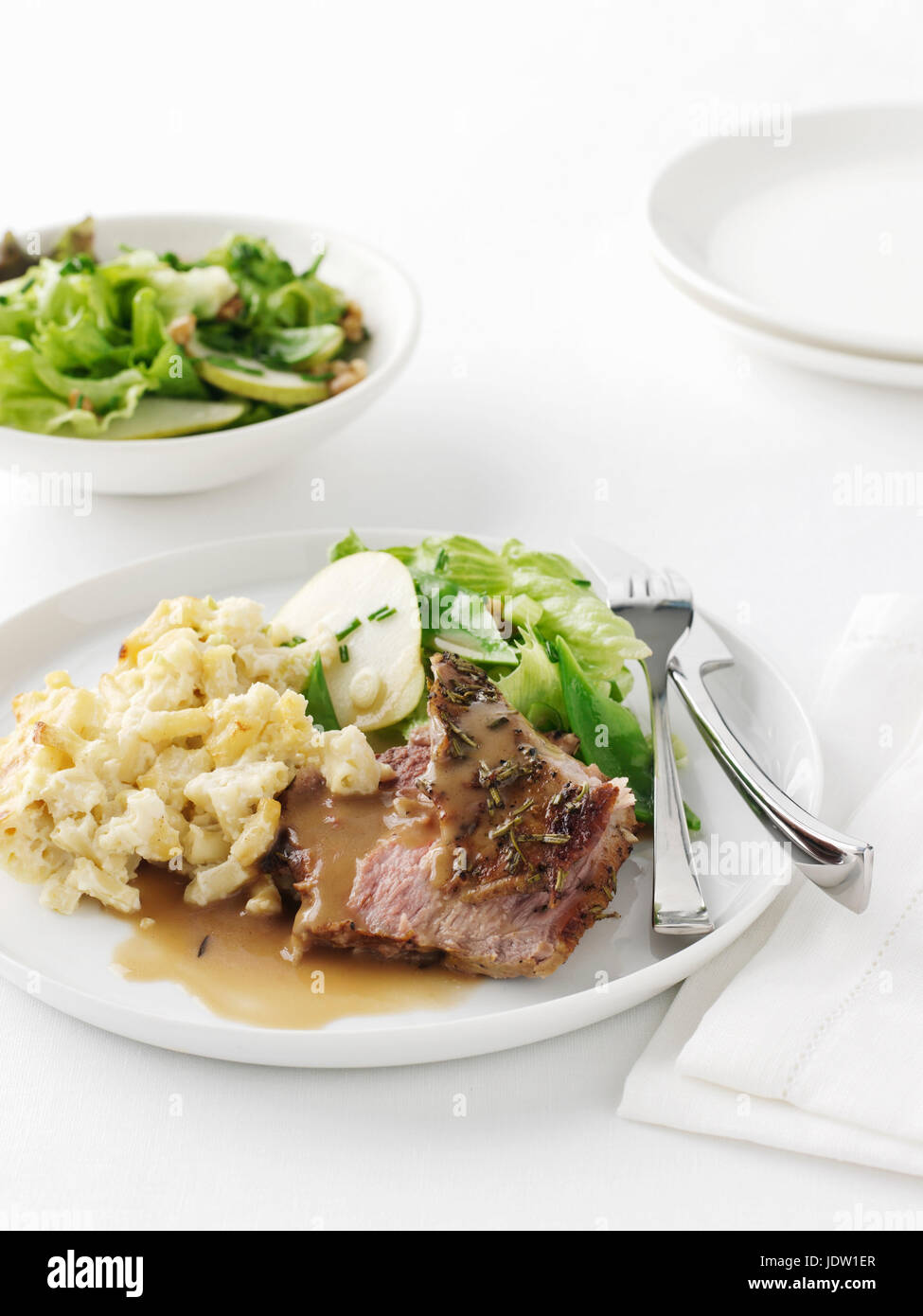 Plate of roast lamb with potatoes Stock Photo