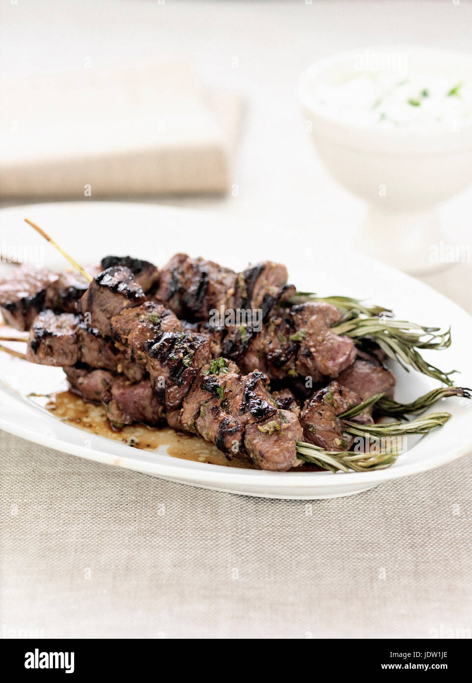 Plate of meat kebabs and herbs Stock Photo